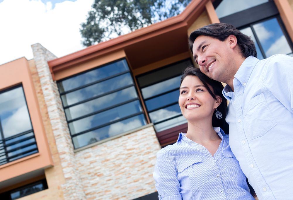 Couple daydreaming of buying a beautiful house