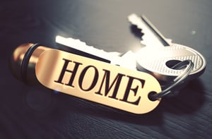 Keys and Golden Keyring with the Word Home over Black Wooden Table with Blur Effect. Toned Image.-1