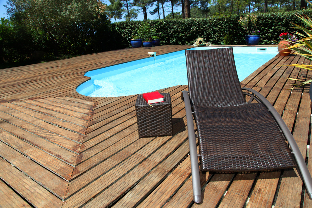 View of long chairs set by swimming pool-1